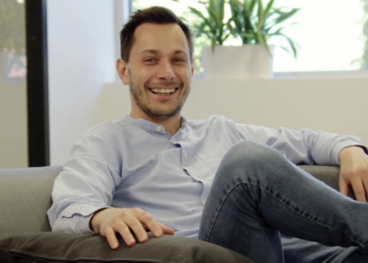 Portrait of Maxime Lavoie seated on a sofa, from the Goodfood years